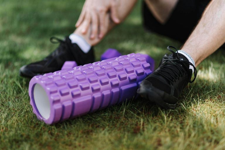 Runner with a foam roller attempting Marathon recovery