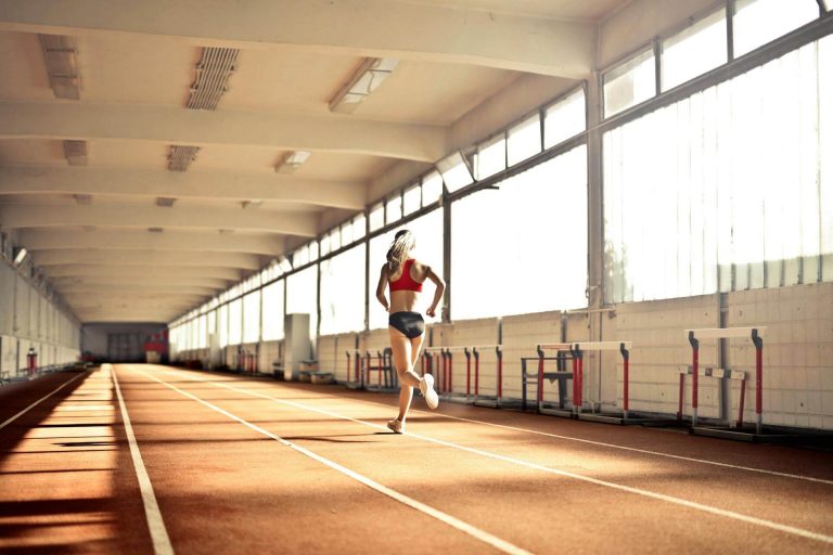 Woman running fast on an atheltics track