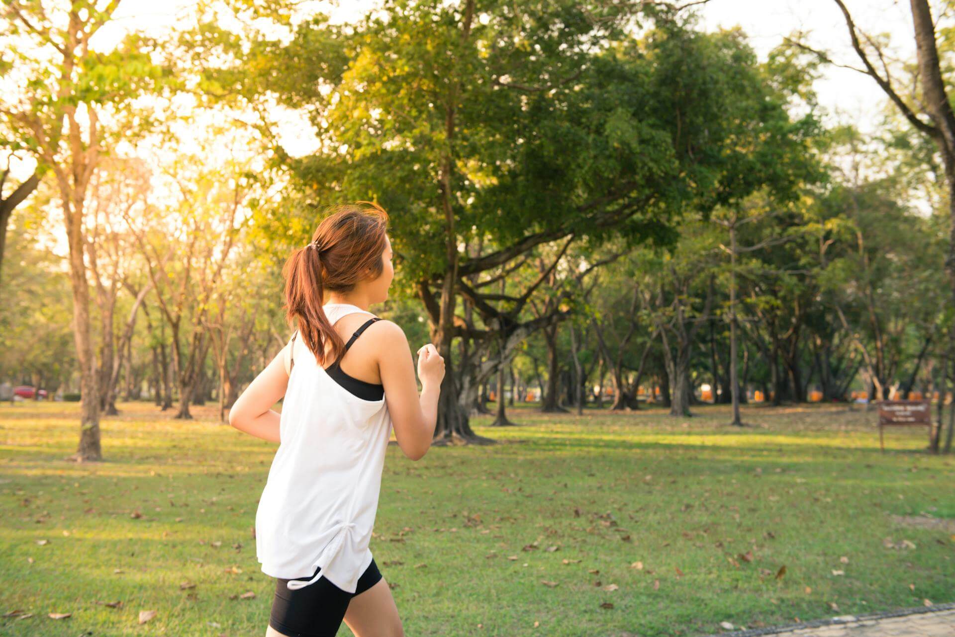 Woman running in a park, taking it easy, a zone 2 run
