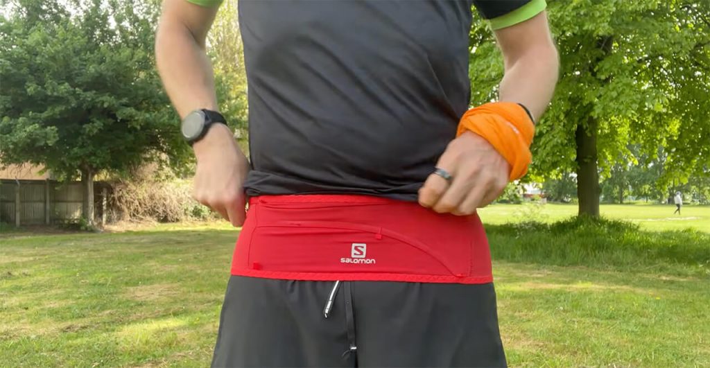 best running belt uk - runner wearing a waist pack on a trail run