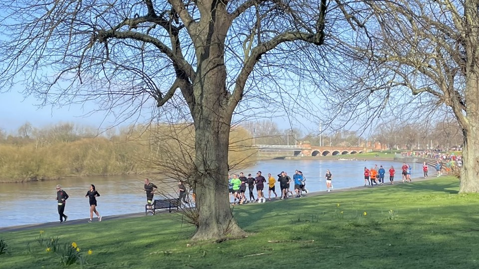 runners taking part in parkrun tourism uk on a scenic lakeside course