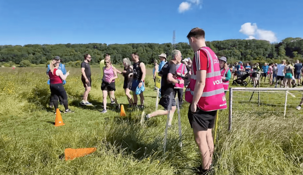 parkrun volunteer roles timekeeper using the app at the finish line