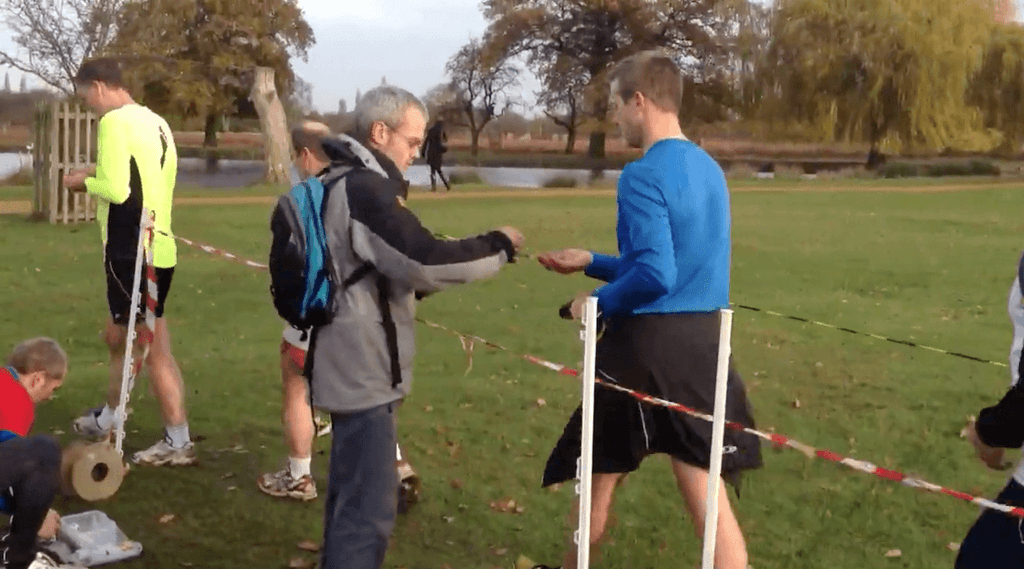 First time at parkrun: runner holding a finish token and barcode after the finish funnel